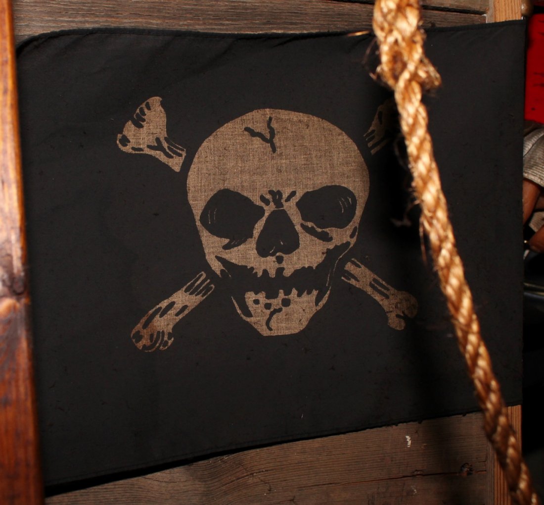 A Small Pirate Flag: With skull and cross bones.