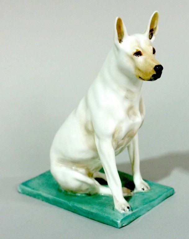 A Royal Worcester Bull Terrier Figurine.: English figurine of a dog depicted seated on a rectangular pale green base. Inscribed on bottom "Bull Terrier Modelled by Davis Lindne" and with black Royal Worcester mark with 2931. Height 5 inches.