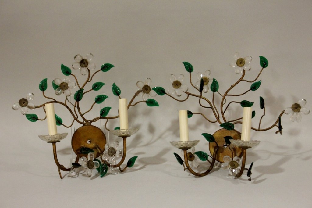 Pair of Italian Sconces: With Italian gilt metal and crystal sconces with floral daisy decoration in clear and green glass. Flowers radiating from circular wall mount. Each sconce with two electrified lamp arms. 11.75 inches 