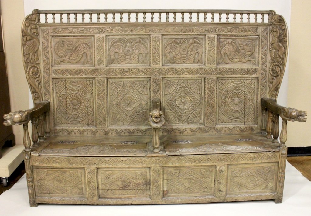 18th C. Large Welsh Carved Oak Hall Bench.: Welsh marriage bench with pickled finish and two lift top storage seats. Dated 1723. Decorated with carved floral circular medallions, birds, fish, and serpent forms. Height 60.5 inches, width 84.5 in