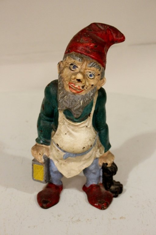 A Painted Cast Iron Doorstop: In the form of a gnome holding keys and a lantern.