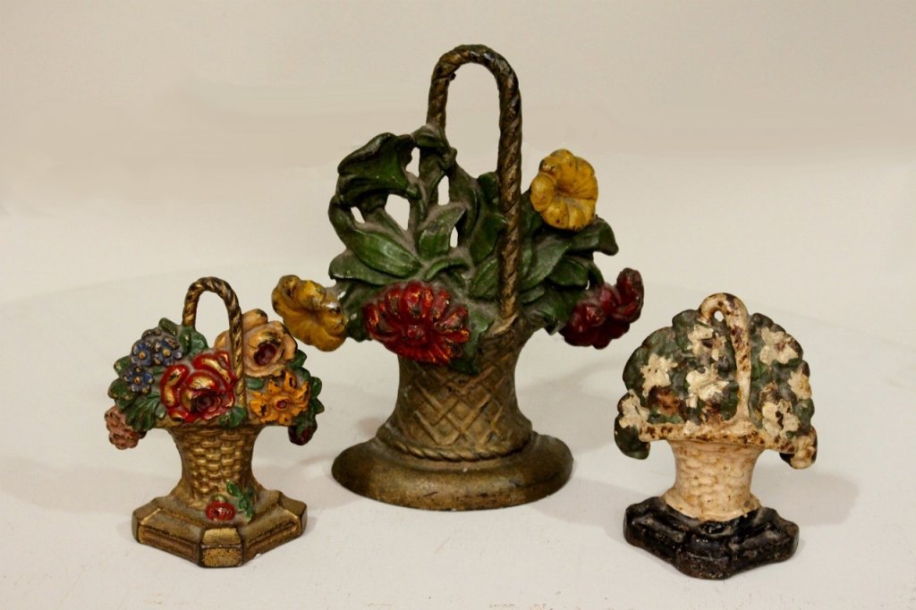 A Group of Cast Iron Doorstops: In the form of baskets of flowers.