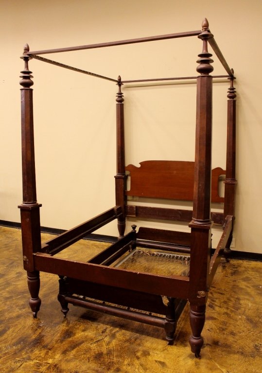 Mid 19th C. Poster Bed: Wooden four poster bed with coordinating trundle. Each with turned wood posts. Feet raised on casters.