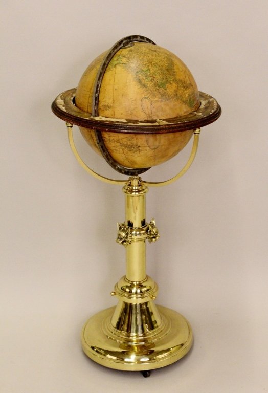 Gilman Joslin Globe on Brass Stand: Late 19th century terrestrial globe by Gilman Joslin raised on a brass metal stand decorated with three animals heads on shaft. Brass stand on casters for movement. Diameter of globe 16 inches.