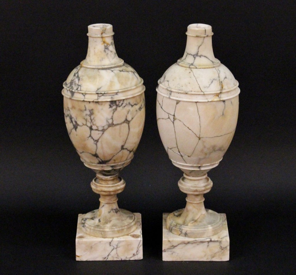Pair of Large Alabaster Urns: 19th century. Cream and grey veined ovoid form alabaster pedestal urns with a socle base raised on square plinth. Overall height 25.125 inches. Intregal plinth measures 7.25 inches square. Provenance: