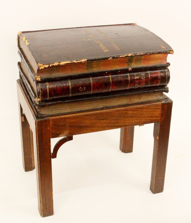 Decorative Antique Ledgers on Wooden Stand: British, early 20th century. Three brown leather bound ledgers from Rowton Houses Limited stacked on top of one another and raised on a wooden stand as decoration. Ledgers adhered to one another inclu