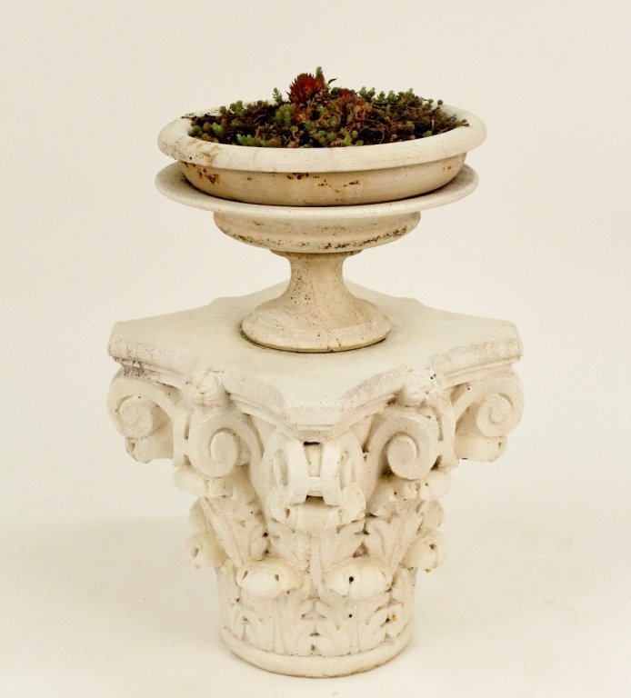 Garden Urn Form Planter on Pedestal: 20th century. Large cast concrete garden planter in the form of a footed urn sitting on the top of an architectural column capital with scrolling and acanthus leaf motif. Overall height 32 inches. Dia