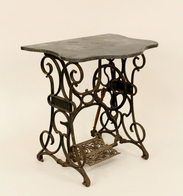 Converted Sewing Table, Marked Superra: Iron sewing table base with scrolled decoration on frame and locked rectangular metal foot pedal, marked on sides "SUPERRA" with later metal wrapped undulating wood top converted into side or occasion