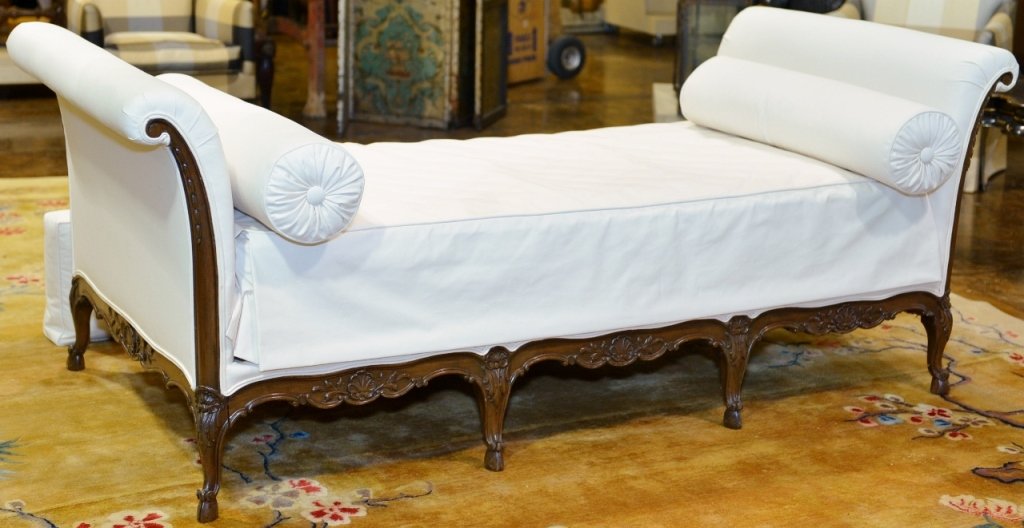Louis XV Style Lit du Jour or Day Bed: French, 19th century. Louis XV style lit du jour or day bed with carved walnut wood frame decorated with shell and foliate decoration. Arms with scrolled decoration. Wood framed day bed raised on eigh