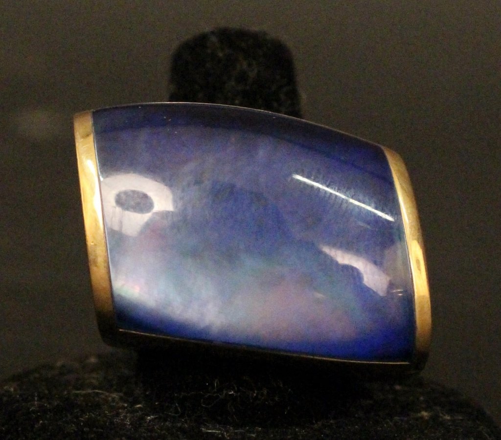 Vhernier 18k Gold Ring: Vhernier 18k yellow gold ring with large mother of pearl, rock crystal quartz and sugilite torqued stone at center. Marked on interior of ring band. US ring size 7. Total weight approximately 47 grams