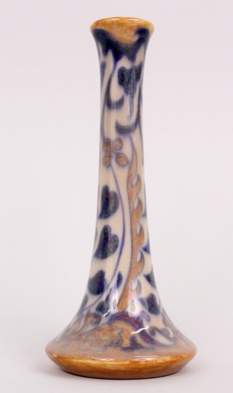 Rookwood Pottery Bud Vase, 1921: Small Art Deco Rookwood pottery vase with hand painted floral and foliate decoration in muted purple, blue, cream and browns. Bottom with Rookwood mark. Also with XXI for execution date of 1921 and 23