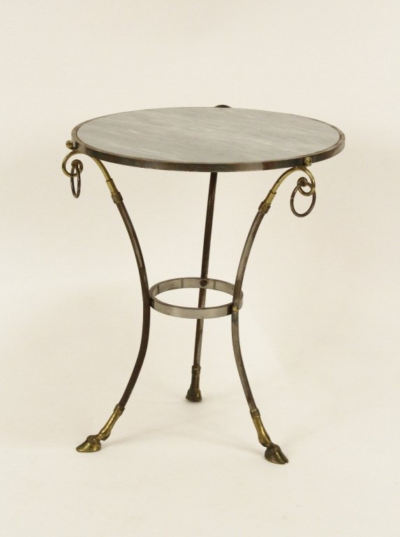 Marble Top Metal Framed Gueridon Table: 20th century. Gueridon table with a circular grey marble top on a steel tripod base with brass trim and hooved feet. Table with three circular handles. Height 24 inches, diameter of top 20 inches. Pro