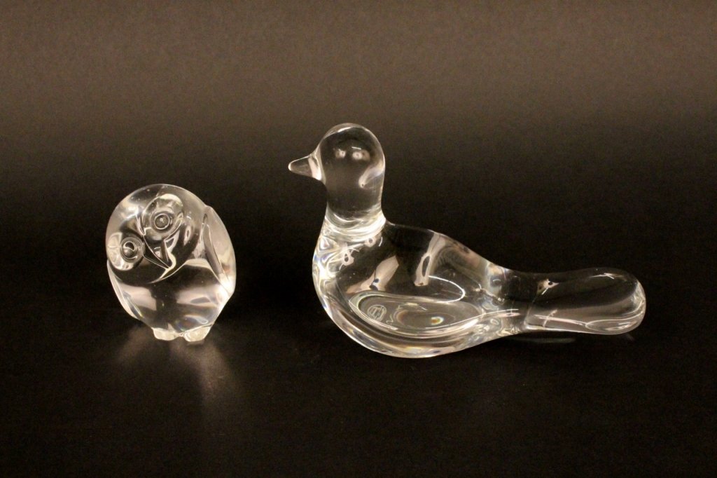 Steuben Glass Owl & Baccarat Bird: 20th century. Steuben glass owl paperweight or figurine with its head tilted to one side, signed on the bottom "Steuben". Baccarat crystal bird paperweight or figurine depicted in a streamlined fashio
