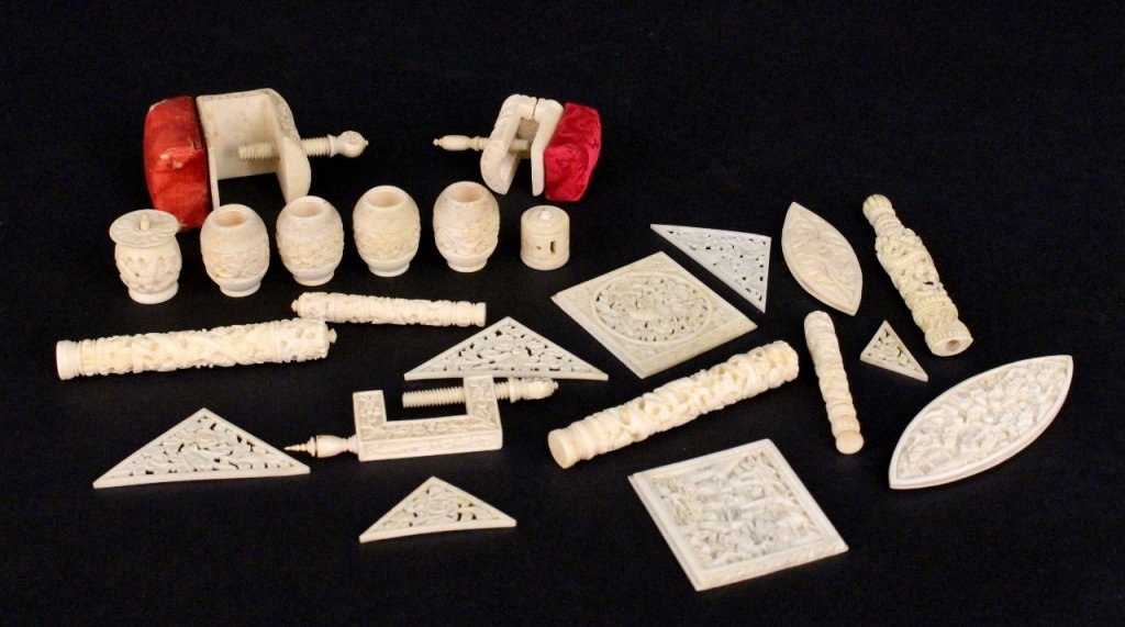 Group of 23 Carved Ivory Sewing Items: Group of twenty-three carved ivory sewing items comprising two clamp form pin cushions, one sewing clamp, five needle holders, four bobbins, two thread spools, two tatting shuttles, and seven quilting