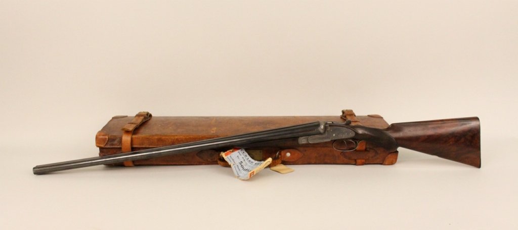 Watson Bros.12 Gauge Double-Barrel Shotgun: English, late 19th century (circa 1898). 12 gauge double-barrel shotgun with walnut stock and detailed metal engraving with scrolled foliate decoration--marked "Watson Bros" on both sides of metal wor