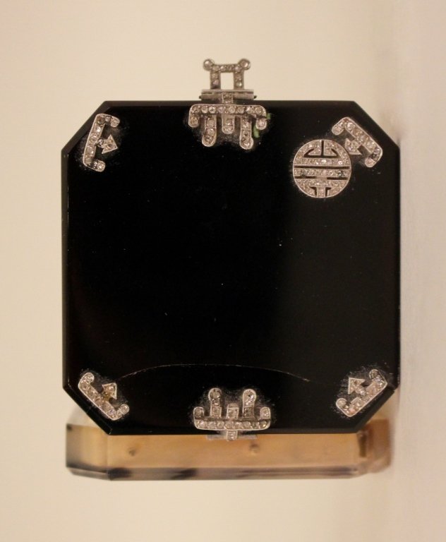 Art Deco Diamond & Onyx Vanity Case.: By Lacloche Freres, Paris, Circa 1925.The hinged square box with diamond decoration on onyx at top. Bottom appears to be agate. Interior with lipstick holder and small compartment. 2.125 inches square