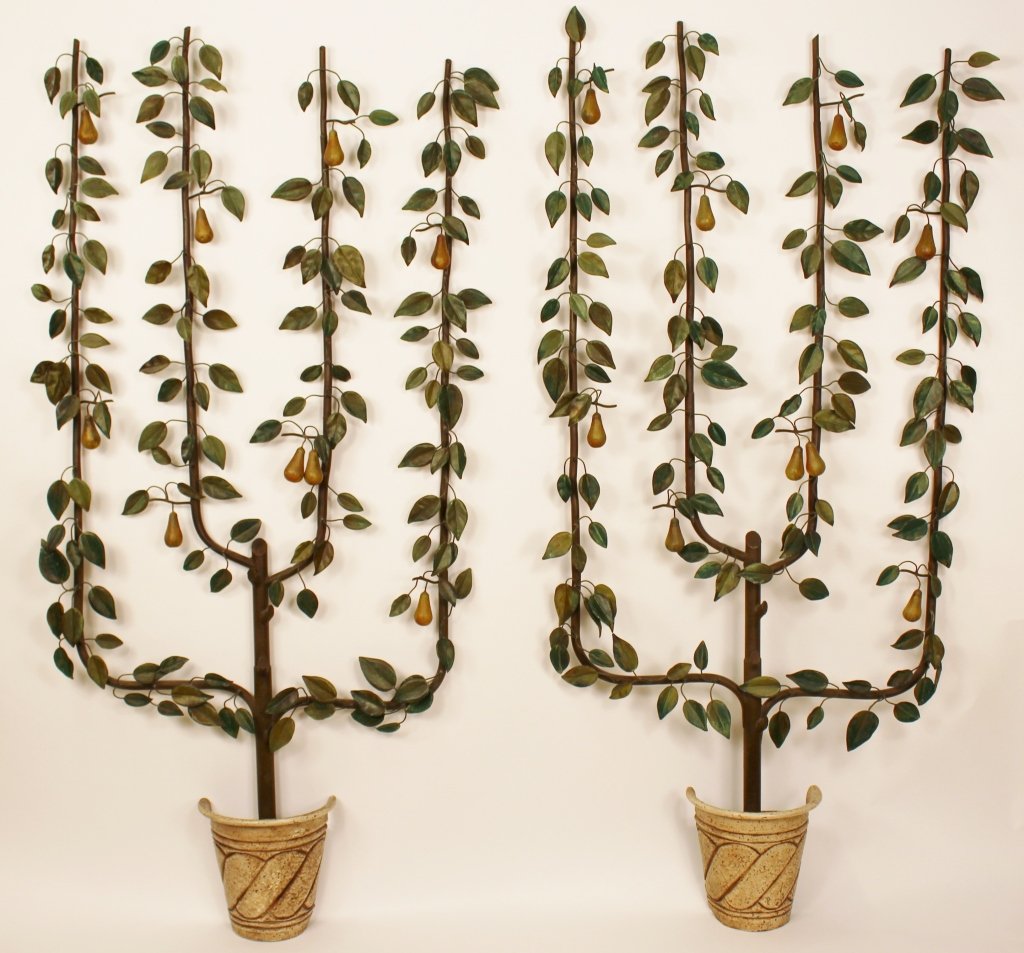 Pair of Painted Metal Espailed Pear Tree Sculpture: 20th century. Pair of polychrome hand painted metal sculptures of espalied pear trees planted in half pot forms. Each fruit tree depicted with four vertical stylized branches with green leaves and sca