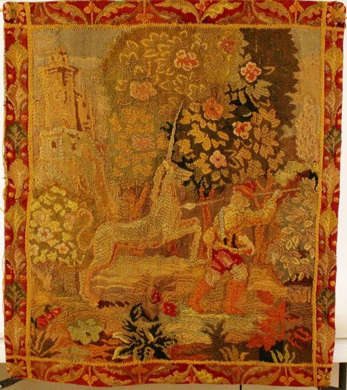 19th C. Hand Woven Tapestry w/Unicorn: Continental School, 19th century. Hand woven wall hanging tapestry depicting a white horned unicorn beside a male hunter with his back turned to the viewer holding a spear. Figures in an outdoor setti