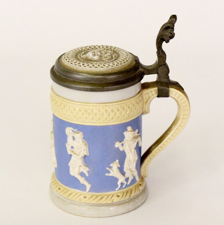 Villeroy & Bach Mettlach Stein: German, first half 20th century (circa 1919). Villeroy & Bach Mettlach half liter bier stein with light blue and white decoration with Bacchanlian head on top surrounded with diamond motif border on h