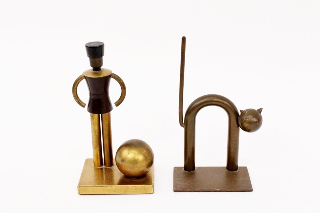 Two Chase Brass Decorative Objects, Bookends: Chase Brass & Copper Co., USA. Group of two Art Deco styled decorative objects including a Walter Von Nessen designed cat bookend of signature tubular form and a sentinel on a stand adjacent to a roun