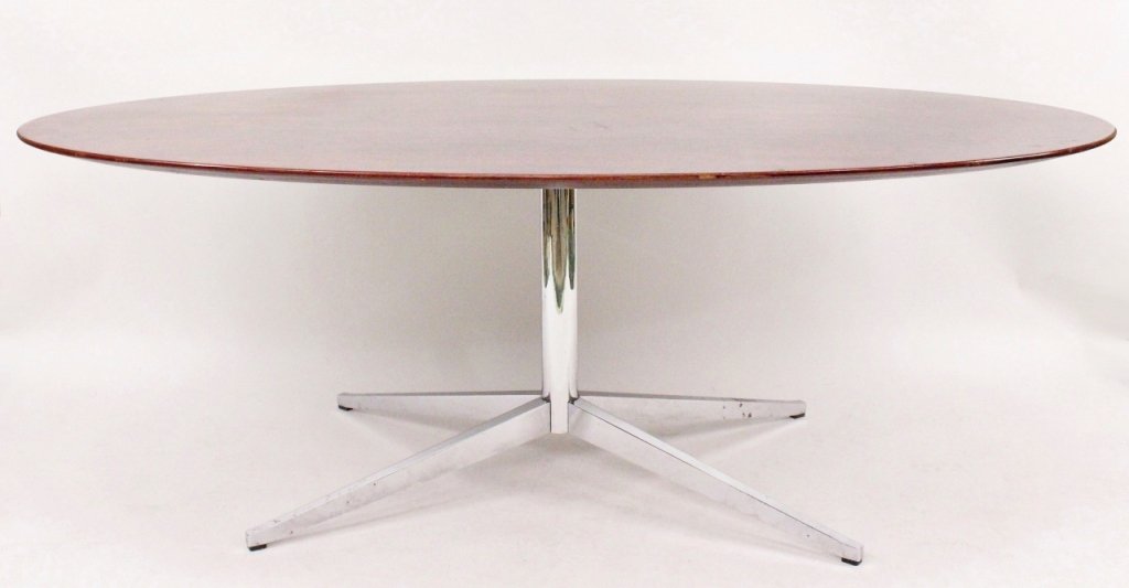 Florence Knoll Rosewood Oval Dining Table: Knoll International, circa 1973. Florence Knoll Brazilian rosewood dining table with oval top raised on chromed steel pedestal base. Height 28 inches, width 77.75 inches, depth 48 inches.