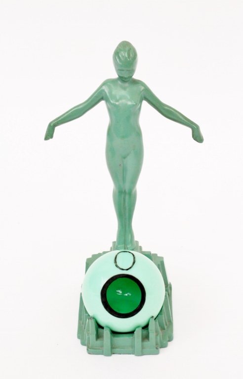 Frankart Figural Ashtray (T325): Frankart (American 1920s-1930s), No. T325. Original Frankart figural ashtray depicting a young female nude with arms outstretched behind a removable jade green glass orb or globe form ashtray or recep
