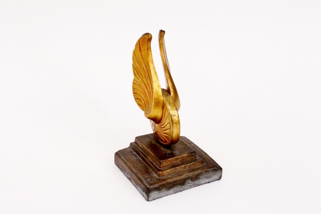 Frankart Winged Wheel Bookend: Frankart (American 1920s-1930s), number unknown, likely manufactured after 1935. Frankart bookend depicting a winged wheel in a gold finish on a stepped base with bronzed finish. Marked on edge "FRANK