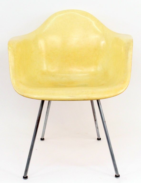 Eames for Herman Miller Shell Chair: Mid-century modern Charles and Ray Eames for Herman Miller pale yellow molded fiberglass shell chair with textured surface. Armchair raised on metal base with four legs. Label from Herman Miller, Zeel
