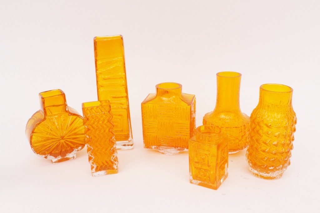 7 Baxter for Whitefriars Tangerine Art Glass Vases: Geoffrey Baxter (British 1922-1995) for Whitefriars. Group of seven 20th century British Whitefriars art glass vases in tangerine orange of varying size and shape. Some with labels on bottom, others m