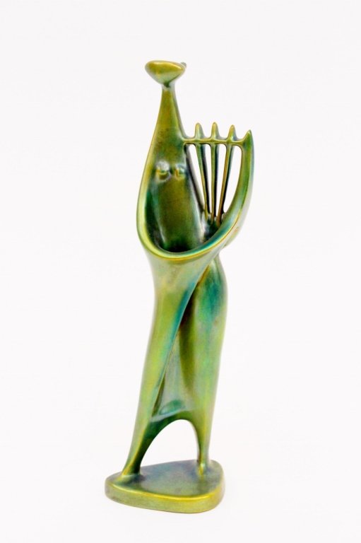 Zsolnay Iridescent Glazed Pottery Musican Figure: Hungarian Zsolnay iridescent green glazed pottery figurine depicting a musician playing the harp. Figure depicted in a modern minimal and streamlined abstracted manner. Woman holding harp on hip and s
