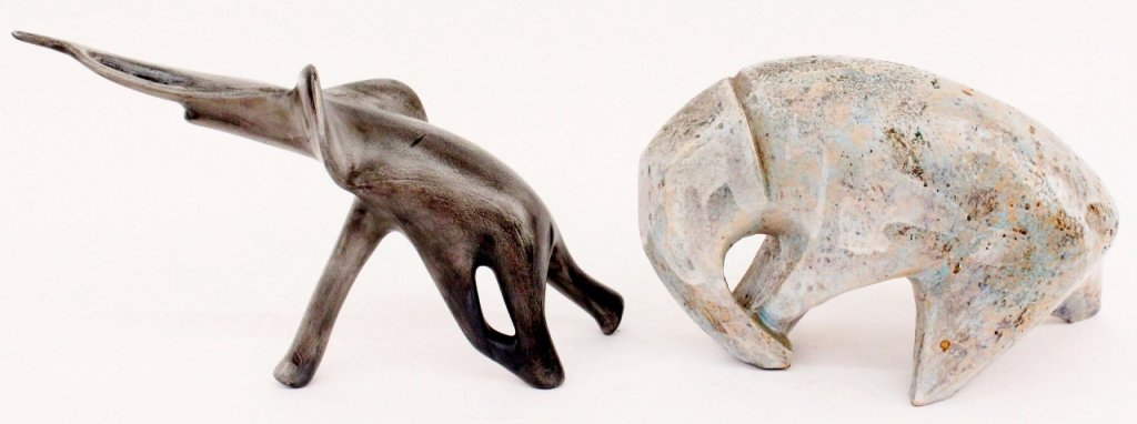 Two Modern Elephant Sculptures: Two unmatched sculptures depicting abstracted elephants including one composed of clay with blue, white and grey glazes portraying the animal in predominately geometric forms with trunk tucked by fron