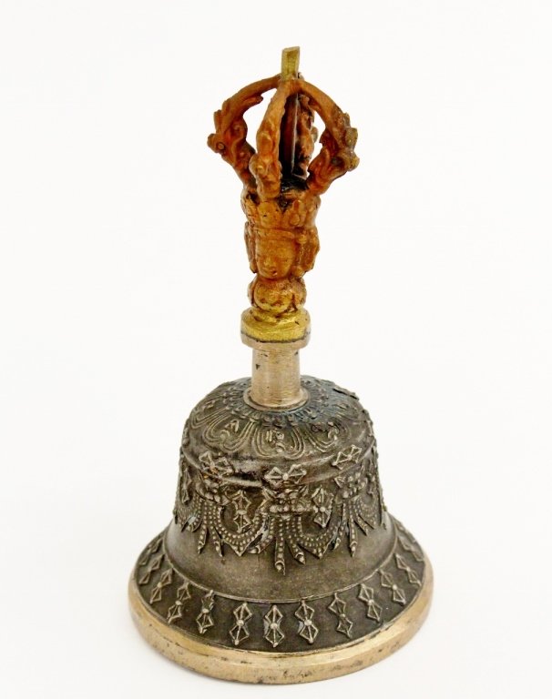 Sino-Tiebetan Prayer Bell: Sino-Tiebetan Buddhist metal prayer bell with crown form surmounted handle above a crowned Buddha face above shaft connecting to bell form with swag form decorations. Unmarked. Height 5.5".