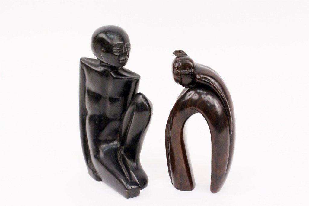 Two Carved Wood Figures: Two carved wood figures including a Balinese carving depicting a figure with back curved and eyes closed, marked on bottom "I.B. MARKA SUMAMPAN" and a unmarked seated nude figure with hands underneath
