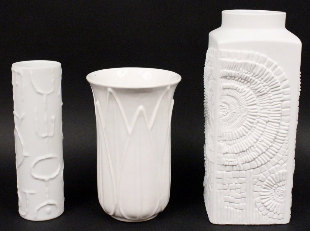 Group of Three European White Vases, Marked: Group of three white European designed table vases including a Cuno Fischer (German 1914-1973) for Rosenthal cylindrical bisque vase with sketch like motif, marked on bottom; a Kaiser bisque rectangul