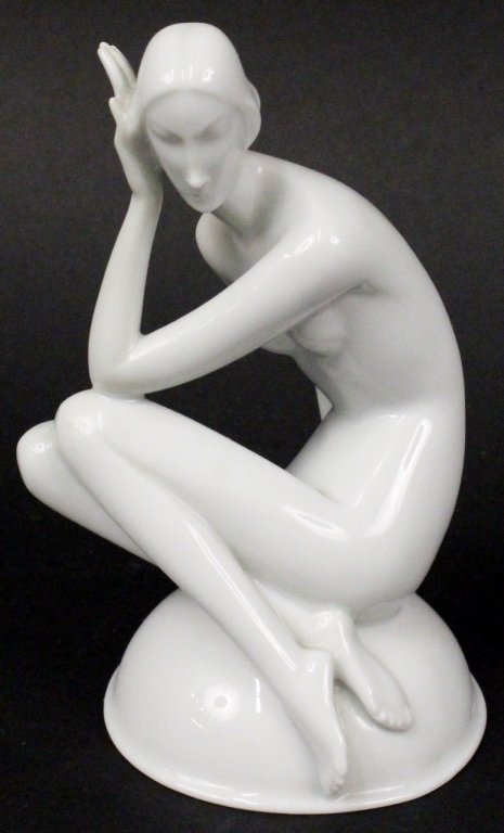 Rosenthal White Glazed Art Deco Female Nude: Rosenthal, Germany. 20th century white glazed porcelain figurine of an Art Deco female nude sitting on a circular dome form base with back of hand resting on side of face and knees bent. Graceful fema