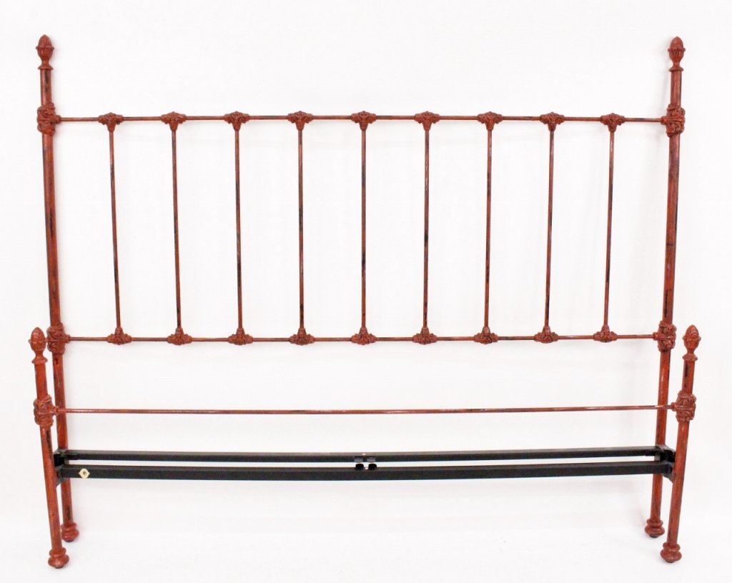King Size Red Painted Cast Iron Bed Frame: King size heirloom bed frame composed of cast iron painted red with antiqued or weathered finish decorated with acorn finials at top of headboard and footboard posts with additional scrolled foliate c