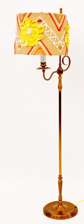 Contemporary Brass Colored Floor Lamp w/Floral Shade: Contemporary brass colored floor lamp with circular base with long shaft with scrolled accent with one electrified lamp with burlap drum shade decorated with yellow fabric flowers and red, white, oran