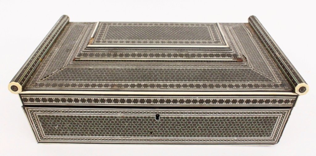 19th Century Ebonized Wood & Ivory Sewing Box: 19th century. Large rectangular sewing box with intricate decoration forming geometric designs composed of ivory and ebonized wood with green painted accents. Paneled top with cylindrical side arms th