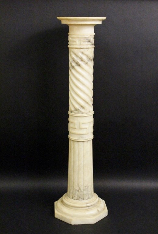 Carved Alabaster Pedestal: Carved alabaster (in cream and grey tones) floor pedestal of columnar form with circular display top above twisting on shaft above banded Greek key like motif above ribbed expanse terminating at stepp