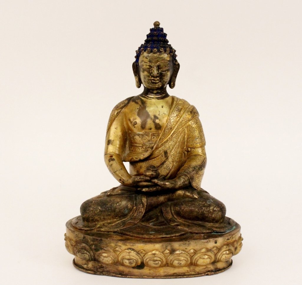 Chinese Gilt Bronze Buddha Statue: Chinese, Late 19th/Early 20th century. Chinese gilt bronze metal statue in the form of a seated Buddha. Buddha wearing a robe with scrolled foliate motif throughout. Buddha with blue painted accents a