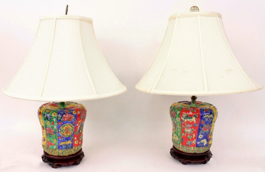 Pair of Oriental Porcelain Bell Pepper Form Lamps: Pair of Chinese porcelain bell pepper form lidded jars later converted into electrified lamps. Each with exterior brightly colored in red, blue, green and yellow with bird, prunus fruit and floral dec