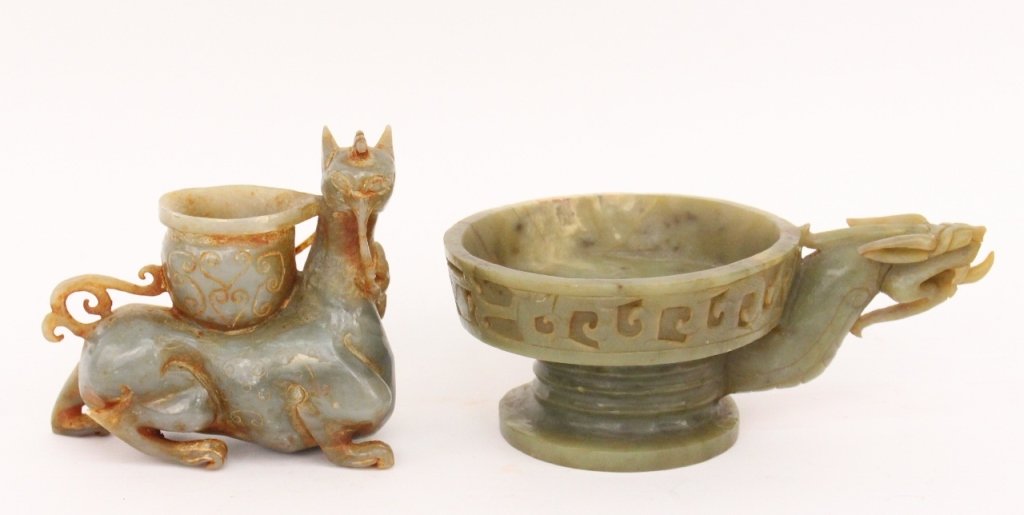 Two Oriental Carved Mythical Beast Items: Two Asian hand carved mythical beast motif items comprising of a carved jadeite kylin like animal or dragon with pot resting on back; and a soapstone carving of a mythical beast or dragon with tongue 