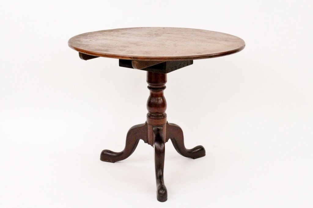 Queen Anne Walnut Round Tilt Top Table: English,19th century. Queen Anne style round tilt top table composed of stained walnut with top above baluster form turned wood shaft above three cabriole legs. Height 28.25", diameter 34.3".
