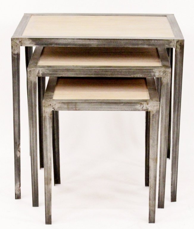 Three Metal Framed Bleached Oak Tables: Three modern streamlined graduated nesting tables with rectangular bleached oak wood tops with steel frames and raised on four legs. Tallest table height 22", width 21.75", depth 15.75". Smallest tabl