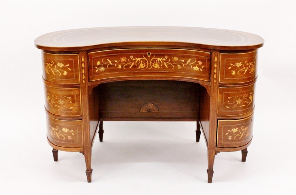 19th C. Edwardin Inlaid Kidney Desk: British,19th century. Edwardian inlaid kidney desk with inset tooled brown leather kidney shaped top surrounded by inlaid decoration of flowers and cornucopias above central pull out drawer in front o