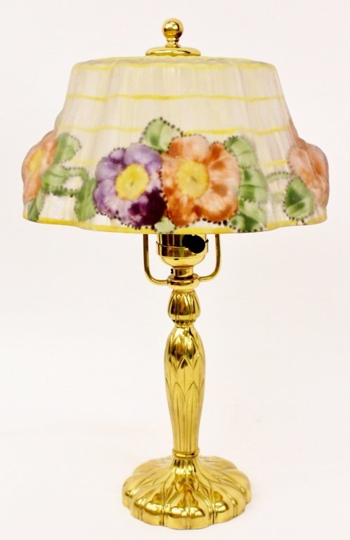 Pairpoint Puffy Reverse Painted Glass Lamp: American, 20th century. Pairpoint puffy boudoir or table lamp (circa 1920) with pink and purple floral and green leaf decoration reverse painted on molded glass shade above a brass metal lamp base mar