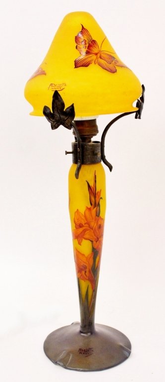 André Delatte Cameo Art Glass Lamp: André Delatte (French, 1887-1953), cameo art glass table or boudoir lamp with four flying butterflies on golden yellow glass shade held up by three leaved wrought iron supports at top of green cut to
