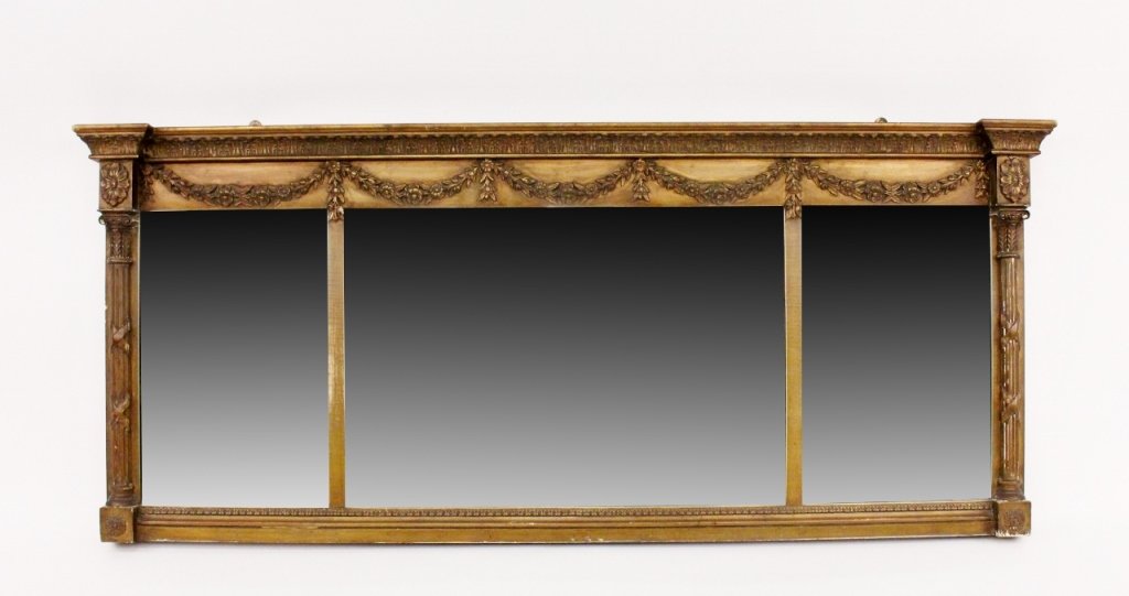 Gilt Wood Framed Triple Panel Mirror: Late 19th/Early 20th century. Gilt wood and gesso horizontal aligned mantle or wall mirror with three looking glass panels within frame with floral swag motif at top below leaf tip decorated entablatu