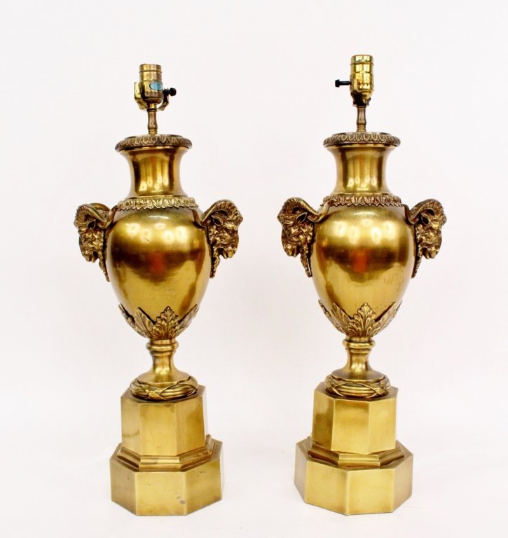 Pair of Brass Ram's Head Lamps: Chapman Lamp Manufacturing Company (American, last quarter of 20th century). Pair of matching brass metal urn form table lamps with large horned ram's head handles on sides and leaf tip decoration. Ur