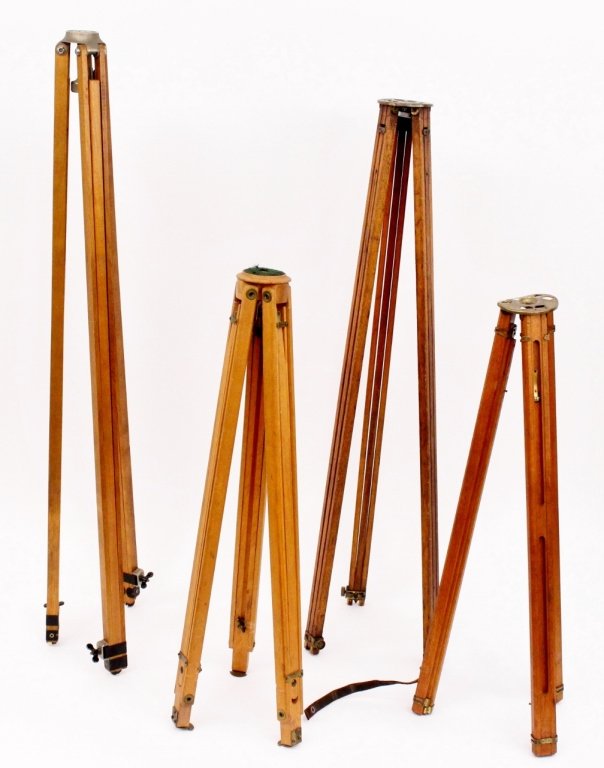Group of Four Vintage Wood Tripods: Group of four vintage wooden camera tripods including a German wood and brass tripod by Ernemann, Dresden; an American wood tripod by The Thalhammer Company, Los Angeles, California; an Eastman Kodak,